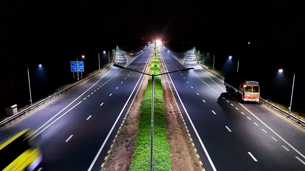 Truck on a lit highway at night