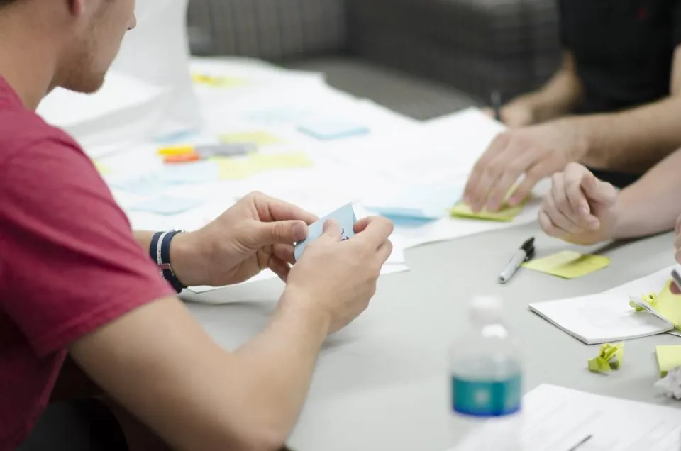 Team planning a shipment schedule at a desk